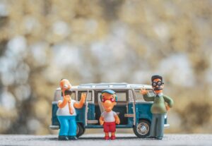 a group of figurines are standing in front of a van