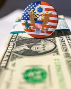 A button on top of a one dollar bill