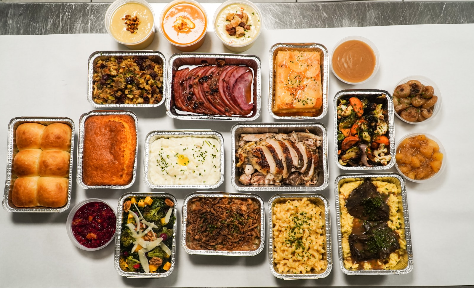 a table topped with lots of trays of food